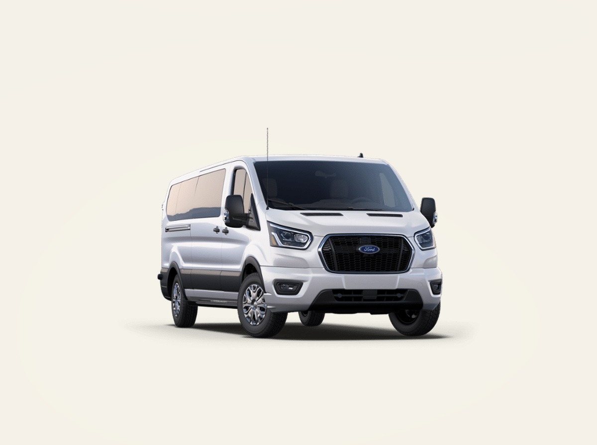 White executive passenger van on a light studio background